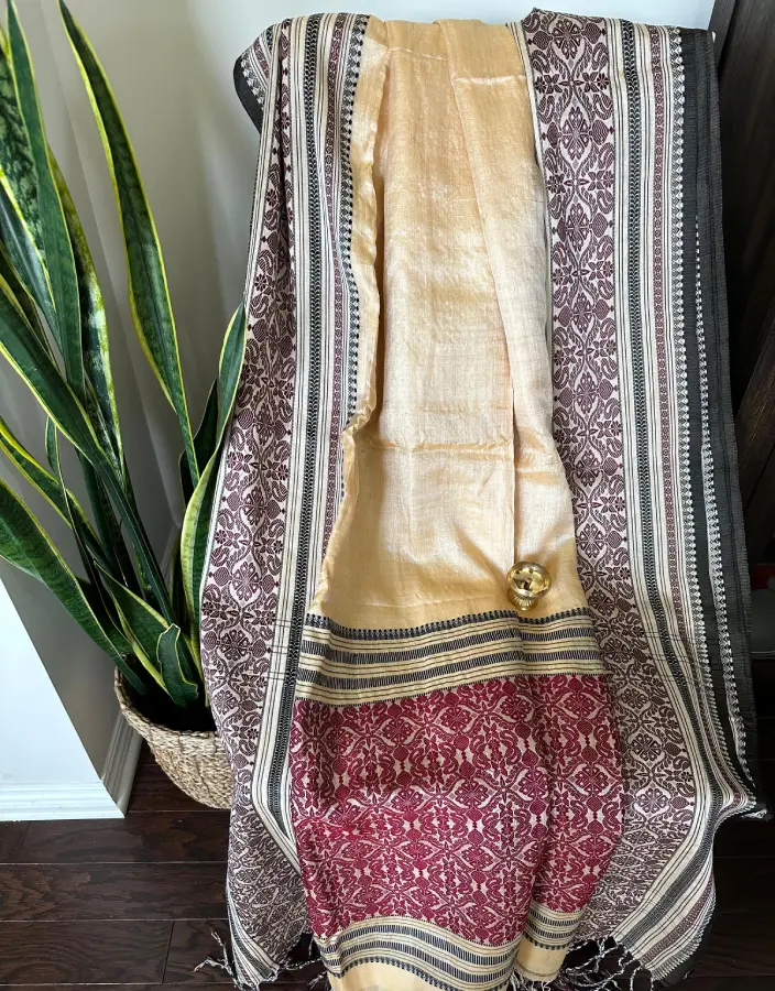 Golden Beige Nobokothi Saree with Maroon Pallu and Traditional Tribal Motifs Golden Beige Nobokothi Saree with Maroon Pallu and Traditional Tribal Motifs