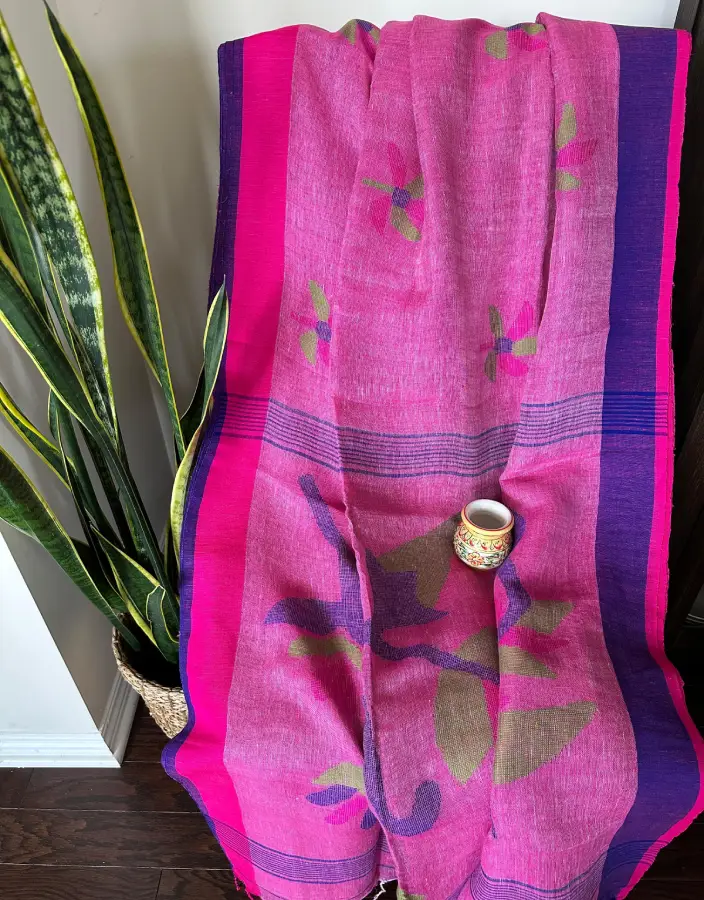 Pink Linen Saree with Purple Border and Abstract Floral Motifs Pink Linen Saree with Purple Border and Abstract Floral Motifs